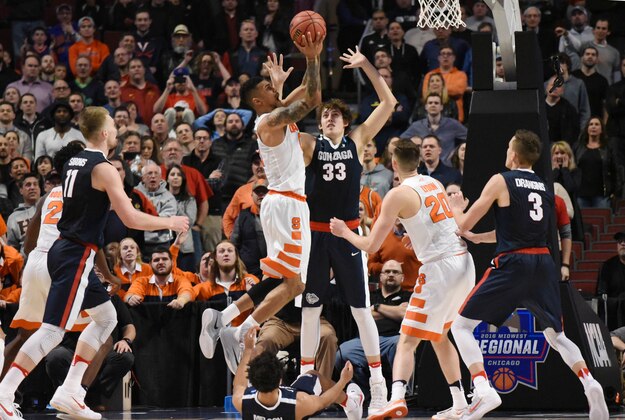 Mar 25, 2016; Chicago, IL, USA; Syracuse Orange forward Michael Gbinije (0) scores the go-ahead basket against Gonzaga Bulldogs forward Kyle Wiltjer (33) during the second half in a semifinal game in the Midwest regional of the NCAA Tournament at United Center. Mandatory Credit: David Banks-USA TODAY Sports