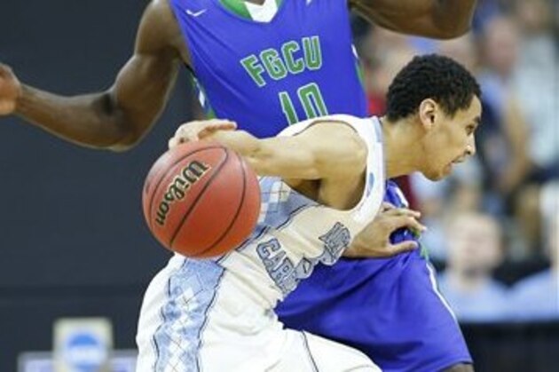 North Carolina guard Marcus Paige (5) moves near Florida Gulf Coast forward Kevin Mickle (10) during the second half of a first-round men's college basketball game in the NCAA Tournament, Thursday, March 17, 2016, in Raleigh, N.C. (AP Photo/Mike Stewart)