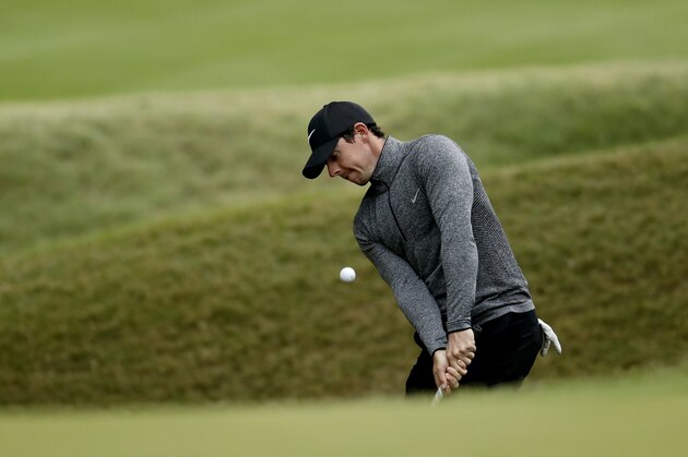 Rory McIlroy, of Northern Ireland, chips onto the sixth green during the round of 16 play against Dustin Johnson at the Dell Match Play Championship golf tournament at Austin County Club Saturday, March 26, 2016, in Austin, Texas. (AP Photo/Charlie Riedel)