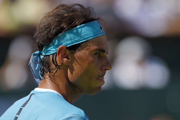 Rafael Nadal, of Spain, looks toward Novak Djokovic, of Serbia, during a semifinal at the BNP Paribas Open tennis tournament, Saturday, March 19, 2016, in Indian Wells, Calif. Djokovic won 7-6 (5), 6-2. (AP Photo/Mark J. Terrill)