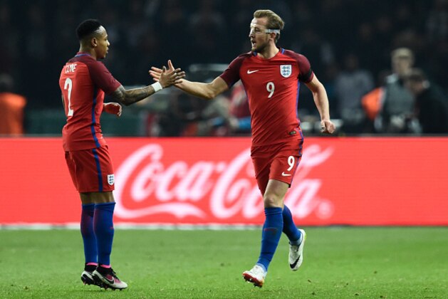 England's striker Harry Kane (R) celebrates scoring with his team-mate defender Nathaniel Clyne  vie for the ball during the friendly football match Germany v England at the Olympic Stadium in Berlin on March 26, 2016. / AFP / ODD ANDERSEN        (Photo credit should read ODD ANDERSEN/AFP/Getty Images)