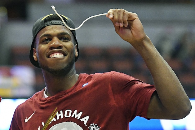 Oklahoma guard Buddy Hield cuts down the net after their win against Oregon during an NCAA college basketball game in the regional finals of the NCAA Tournament, Saturday, March 26, 2016, in Anaheim, Calif. (AP Photo/Mark J. Terrill)