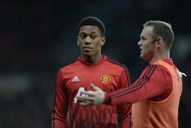 Manchester United's French striker Anthony Martial (L) listens to Manchester United's English striker Wayne Rooney (R) during the warm up before the English Premier League football match between Manchester United and Chelsea at Old Trafford in Manchester, north west England, on December 28, 2015.  / AFP / OLI SCARFF        (Photo credit should read OLI SCARFF/AFP/Getty Images)