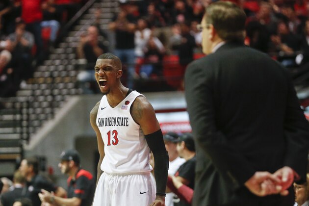 San Diego State forward Winston Shepard, playing in his last home game, celebrates in front of UNLV coach Todd Simon during the first half of an NCAA college basketball game Saturday, March 5, 2016, in San Diego.  San Diego State won 92-56.(AP Photo/Lenny Ignelzi)