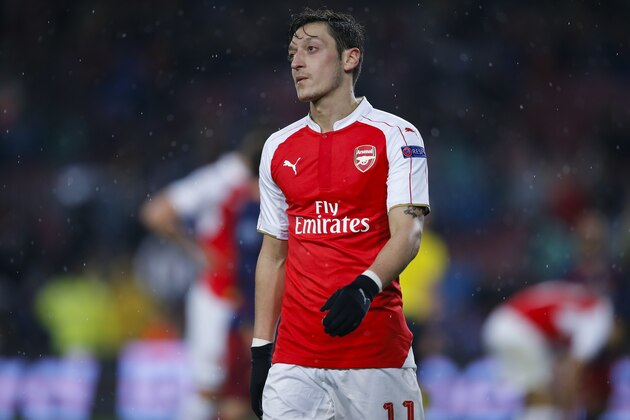 Arsenal's Mesut Ozil leaves the pitch after his team lost the Champions League round of 16 second leg soccer match between FC Barcelona and Arsenal FC 3-1, at the Camp Nou stadium in Barcelona, Spain, Wednesday, March 16, 2016. (AP Photo/Manu Fernandez)