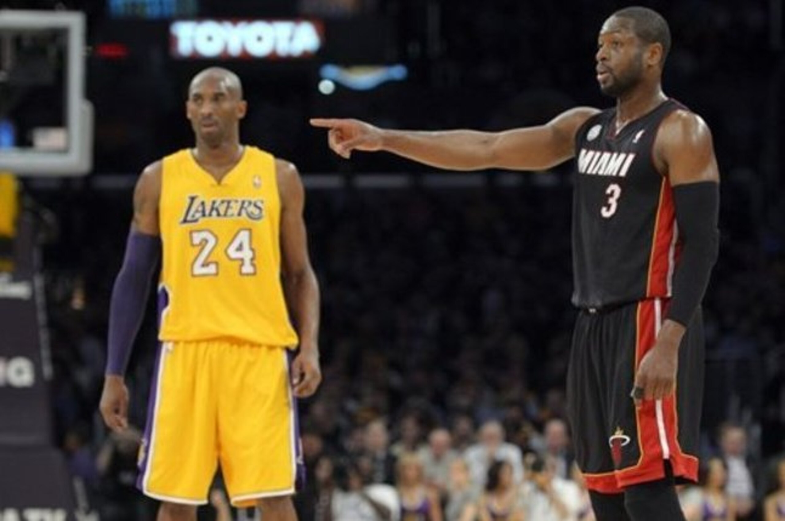 Miami Heat guard Dwyane Wade (3) points as Los Angeles Lakers guard Kobe Bryant (24) stands by during the first half of their NBA basketball game, Thursday, Jan. 17, 2013, in Los Angeles. (AP Photo/Mark J. Terrill)