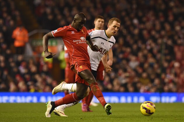 Liverpool's French defender Mamadou Sakho (L) plays the ball under pressure from Tottenham Hotspur's English striker Harry Kane (R) during the English Premier League football match between Liverpool and Tottenham Hotspur at the Anfield stadium in Liverpool, northwest England, on February 10, 2015.  AFP PHOTO / PAUL ELLIS

RESTRICTED TO EDITORIAL USE. No use with unauthorized audio, video, data, fixture lists, club/league logos or live services. Online in-match use limited to 45 images, no video emulation. No use in betting, games or single club/league/player publications.        (Photo credit should read PAUL ELLIS/AFP/Getty Images)