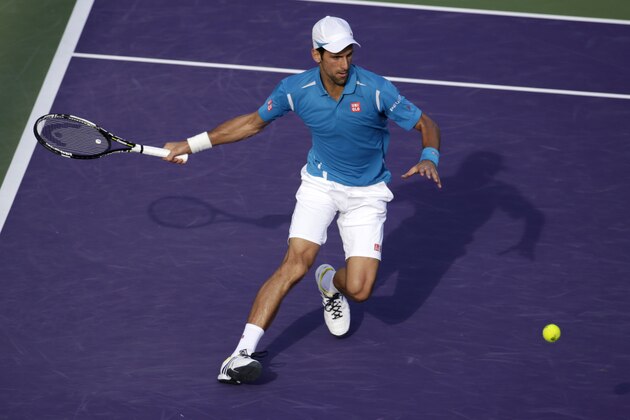 Novak Djokovic, of Serbia, returns to Joao Sousa during their match at the Miami Open tennis tournament, Sunday, March 27, 2016, in Key Biscayne, Fla. (AP Photo/Lynne Sladky)