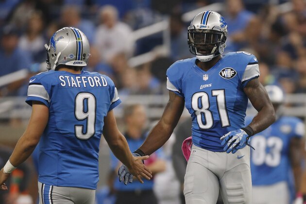 DETROIT, MI - OCTOBER 11: Calvin Johnson #81 celebrities breaking the franchise record of the most catches with Matthew Stafford #9 of the Detroit Lions while playing the Arizona Cardinals at Ford Field on October 11, 2015 in Detroit, Michigan. (Photo by Gregory Shamus/Getty Images)