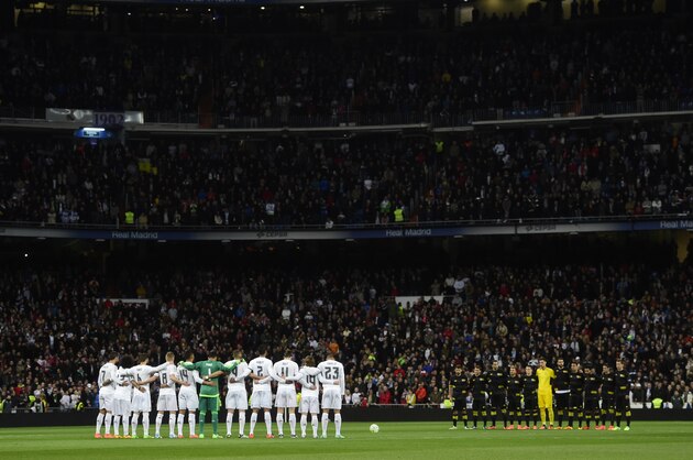 Real Madrid and Sevilla's players observe a minute of silence before during the Spanish league football match Real Madrid CF vs Sevilla FC at the Santiago Bernabeu stadium in Madrid on March 20, 2016. / AFP / PIERRE-PHILIPPE MARCOU        (Photo credit should read PIERRE-PHILIPPE MARCOU/AFP/Getty Images)