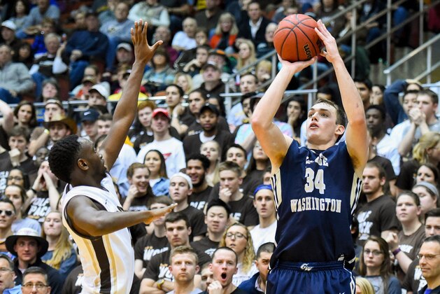 Feb 13, 2016; St. Bonaventure, NY, USA; George Washington Colonials forward Tyler Cavanaugh (34) shoots the ball around St. Bonaventure Bonnies guard Nelson Kaputo (4) during the second half at the Reilly Center.  St. Bonaventure defeated George Washington 64-57.  Mandatory Credit: Rich Barnes-USA TODAY Sports