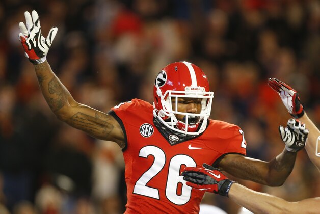 Georgia wide receiver Malcolm Mitchell (26) celebrates with Georgia wide receiver Michael Bennett (82) after a touchdown catch against Auburn in the first half of an NCAA college football game Saturday, Nov. 15, 2014, in Athens, Ga. (AP Photo/John Bazemore)