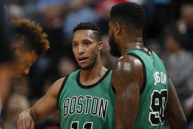 Boston Celtics guard Evan Turner (11), left, and Boston Celtics forward Amir Johnson (90) in the first half of an NBA basketball game Sunday, Feb. 21, 2016, in Denver. (AP Photo/David Zalubowski)