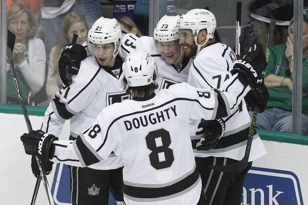 Los Angeles Kings center Tyler Toffoli, center, is congratulated Nick Shore (21), left wing Dwight King (74) and defenseman Drew Doughty (8) after scoring a goal against the Dallas Stars during the first period of an NHL hockey game Tuesday, March 15, 2016, in Dallas.  Los Angeles won 5-2.  (AP Photo/Tim Sharp)