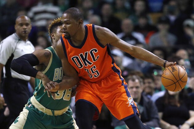Oklahoma City Thunder's Kevin Durant (35) looks to move on Boston Celtics' Marcus Smart (36) during the first quarter of an NBA basketball game in Boston, Wednesday, March 16, 2016. The Thunder won 130-109. (AP Photo/Michael Dwyer)