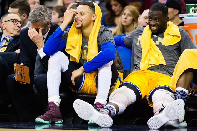 CLEVELAND, OH - JANUARY 18: Stephen Curry #30 and Draymond Green #23 of the Golden State Warriors  on the bench during the second half against the Cleveland Cavaliers at Quicken Loans Arena on January 18, 2016 in Cleveland, Ohio. The Warriors defeated the Cavaliers 132-98. NOTE TO USER: User expressly acknowledges and agrees that, by downloading and/or using this photograph, user is consenting to the terms and conditions of the Getty Images License Agreement. Mandatory copyright notice. (Photo by Jason Miller/Getty Images)
