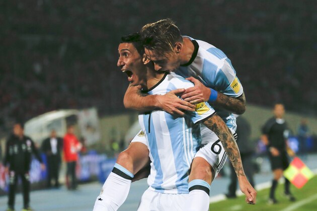 Argentina's Angel Di Maria, left, is embraced by teammate Lucas Biglia after scoring his team's first goal against Chile during a 2018 Russia World Cup qualifying soccer match at the National Stadium in Santiago, Chile, Thursday, March 24, 2016. (AP Photo/ Luis Hidalgo)
