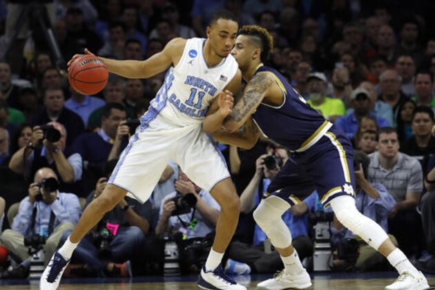 North Carolina's Brice Johnson, left, tries to drive past Notre Dame's Zach Auguste during the second half of a regional final men's college basketball game in the NCAA Tournament, Sunday, March 27, 2016, in Philadelphia. (AP Photo/Matt Rourke)