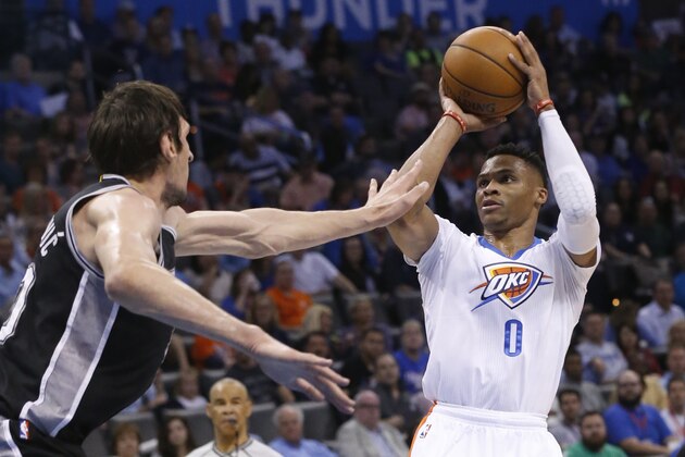 Oklahoma City Thunder guard Russell Westbrook (0) shoots in front of San Antonio Spurs center Boban Marjanovic, left, in the first quarter of an NBA basketball game in Oklahoma City, Saturday, March 26, 2016. (AP Photo/Sue Ogrocki)