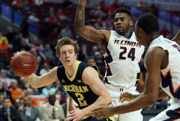 Mar 12, 2015; Chicago, IL, USA; Michigan Wolverines guard Spike Albrecht (2) drives to the basket past Illinois Fighting Illini guard Rayvonte Rice (24) during the second half in the second round of the Big Ten Conference Tournament at United Center. Mandatory Credit: Jerry Lai-USA TODAY Sports