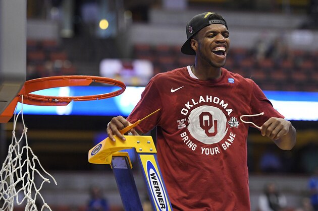 Oklahoma guard Buddy Hield cuts down the net after their win against Oregon during an NCAA college basketball game in the regional finals of the NCAA Tournament, Saturday, March 26, 2016, in Anaheim, Calif. (AP Photo/Mark J. Terrill)