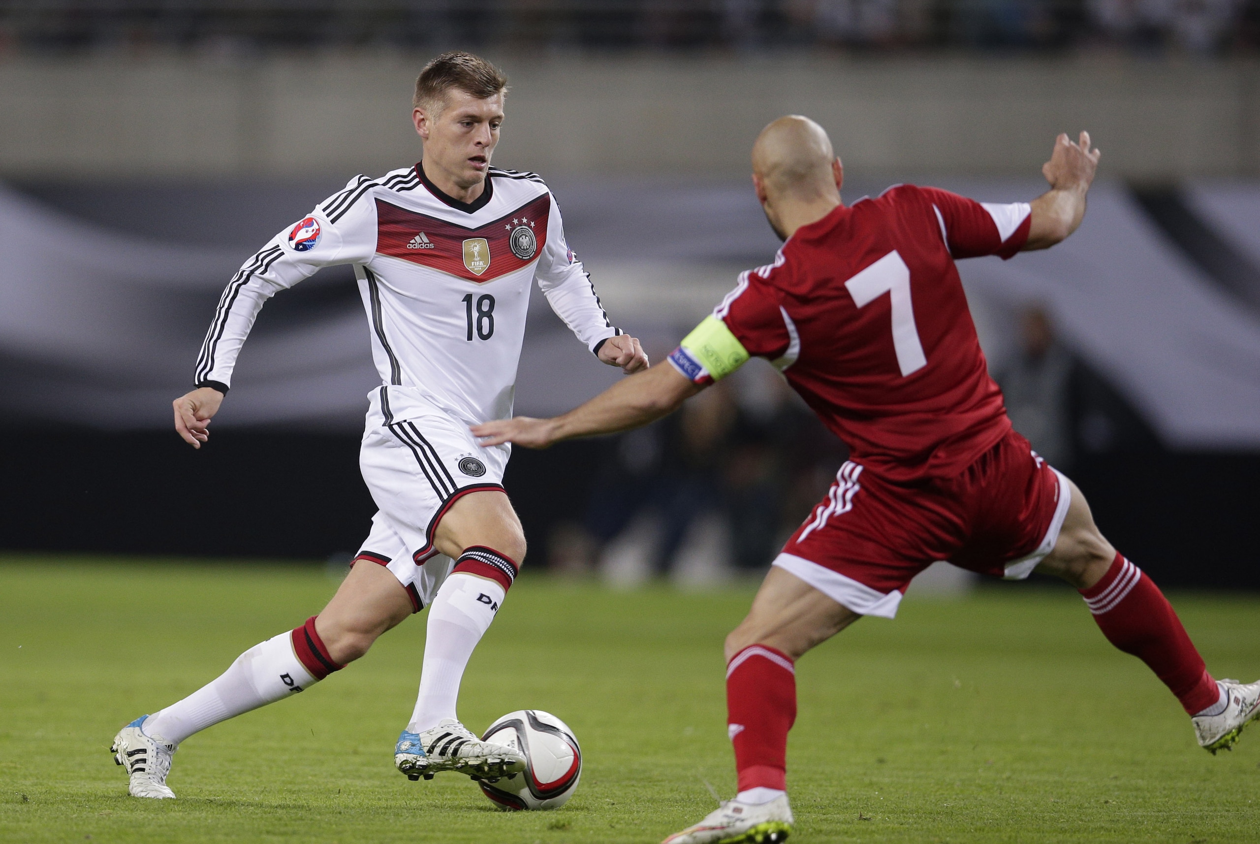 Germany's Toni Kroos, left, goes past Georgia's Jaba Kankava during the Euro 2016 group D qualifying soccer match between Germany and Georgia in Leipzig, Germany, Sunday, Oct. 11, 2015. (AP Photo/Michael Sohn)