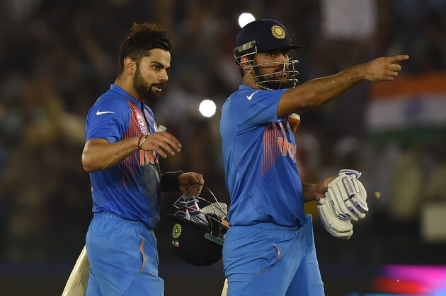 India's Virat Kohli(L)embraces captain Mahendra Singh Dhoni as he celebrates after victory in the World T20 cricket tournament match between India and Australia at The Punjab Cricket Stadium Association Stadium in Mohali on March 27, 2016. / AFP / MONEY SHARMA        (Photo credit should read MONEY SHARMA/AFP/Getty Images)
