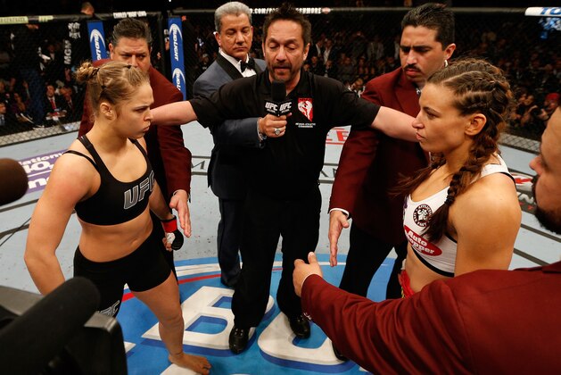 LAS VEGAS, NV - DECEMBER 28:  Ronda Rousey (left) and Miesha Tate (right) face off before their UFC women's bantamweight championship bout during the UFC 168 event at the MGM Grand Garden Arena on December 28, 2013 in Las Vegas, Nevada. (Photo by Josh Hedges/Zuffa LLC/Zuffa LLC via Getty Images)