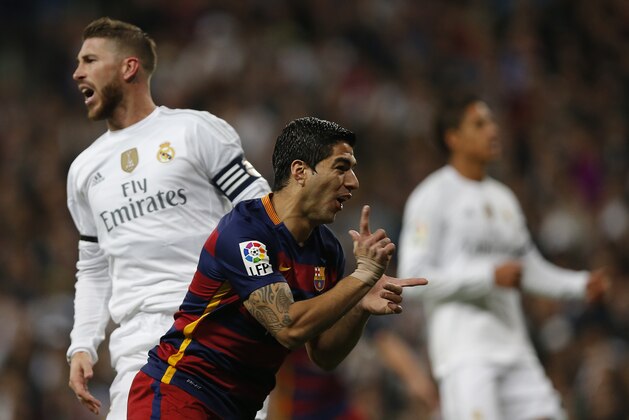 Barcelona's Luis Suarez celebrates after scoring the opening goal during the first clasico of the season between Real Madrid and Barcelona at the Santiago Bernabeu stadium in Madrid, Spain, Saturday, Nov. 21, 2015. Suarez scored twice in Barcelona's 4-0 win. (AP Photo/Daniel Ochoa de Olza)