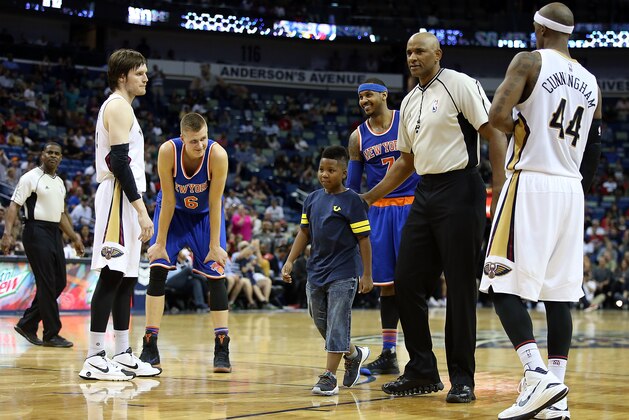 NEW ORLEANS, LA - MARCH 28:  A young boy is escorted off the court after hugging Carmelo Anthony #7 of the New York Knicks during a game against the New Orleans Pelicans during the second half at the Smoothie King Center on March 28, 2016 in New Orleans, Louisiana. NOTE TO USER: User expressly acknowledges and agrees that, by downloading and or using this photograph, User is consenting to the terms and conditions of the Getty Images License Agreement.  (Photo by Sean Gardner/Getty Images)
