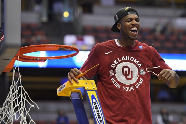 Oklahoma guard Buddy Hield cuts down the net after their win against Oregon during an NCAA college basketball game in the regional finals of the NCAA Tournament, Saturday, March 26, 2016, in Anaheim, Calif. (AP Photo/Mark J. Terrill)