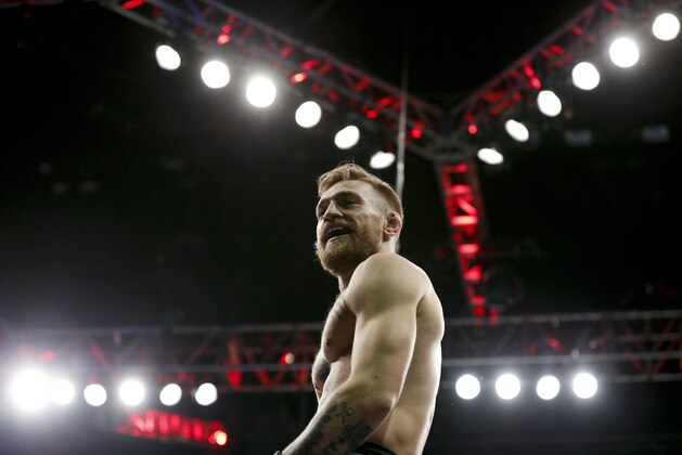 Conor McGregor reacts after defeating Jose Aldo during a featherweight  championship mixed martial arts bout at UFC 194, Saturday, Dec. 12, 2015, in Las Vegas. (AP Photo/John Locher)