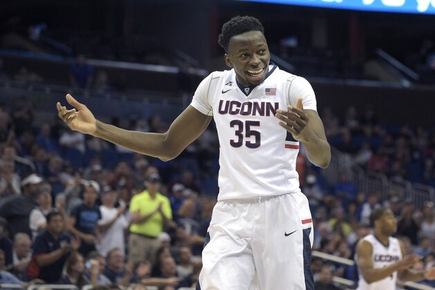 Connecticut center Amida Brimah (35) celebrates on the court at the end of the second half of an NCAA college basketball game against Memphis in the finals of the American Athletic Conference men's tournament in Orlando, Fla., Sunday, March 13, 2016. Connecticut won 72-58. (AP Photo/Phelan M. Ebenhack)