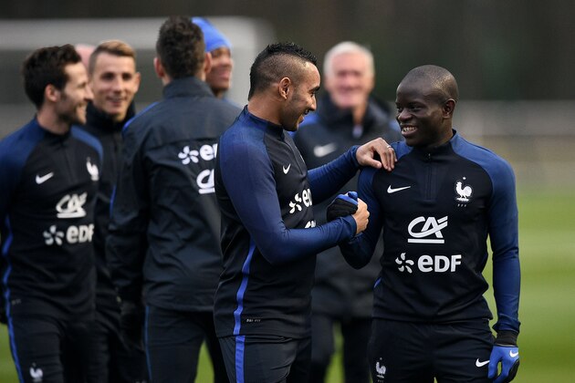 France's midfielder N'Golo Kante (R) jokes with forward Dimitri Payet (C) before a training session in Clairefontaine en Yvelines on March 21, 2016 on the first day of their training ahead of the friendly football match against Netherland to be held on March 25.   / AFP / FRANCK FIFE        (Photo credit should read FRANCK FIFE/AFP/Getty Images)