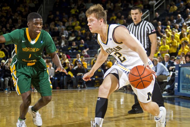 Northern Michigan guard Naba Echols (1) defends Michigan guard Spike Albrecht (2) in the first half of an NCAA college basketball game at Crisler Center in Ann Arbor, Mich., Friday, Nov. 13, 2015. (AP Photo/Tony Ding)