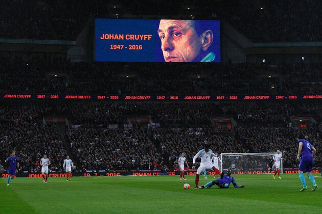 A big screen shows the face of late former Netherlands footballer Johan Cruyff who died on March 24 during a minute of applause on the 14th minute during the international friendly football match between England and Netherlands at Wembley Stadium in London on March 29, 2016. / AFP / Ian Kington / NOT FOR MARKETING OR ADVERTISING USE / RESTRICTED TO EDITORIAL USE        (Photo credit should read IAN KINGTON/AFP/Getty Images)