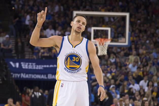 March 27, 2016; Oakland, CA, USA; Golden State Warriors guard Stephen Curry (30) celebrates after making a basket against the Philadelphia 76ers during the third quarter at Oracle Arena. The Warriors defeated the 76ers 117-105. Mandatory Credit: Kyle Terada-USA TODAY Sports