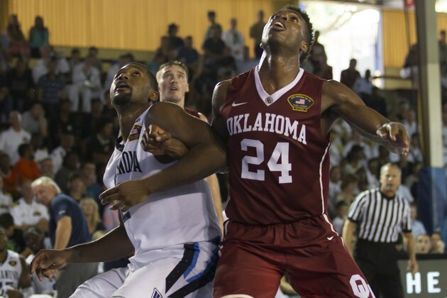 Villanova forward Kris Jenkins, left, battles Oklahoma guard Buddy Hield (24) for position to grab a rebound in the second half of an NCAA college basketball game at the Pearl Harbor Invitational on Monday, Dec. 7, 2015, in Honolulu. Oklahoma beat Villanova 78-55. (AP Photo/Eugene Tanner)