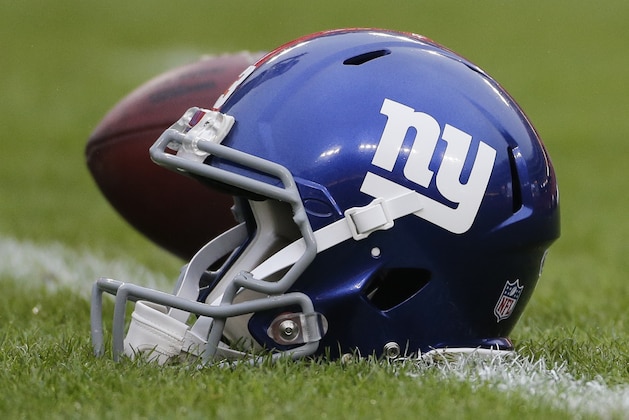 A New York Giants helmet sits on the field before an NFL football game against the Washington Redskins in Landover, Md., Sunday, Nov. 29, 2015. (AP Photo/Mark Tenally)