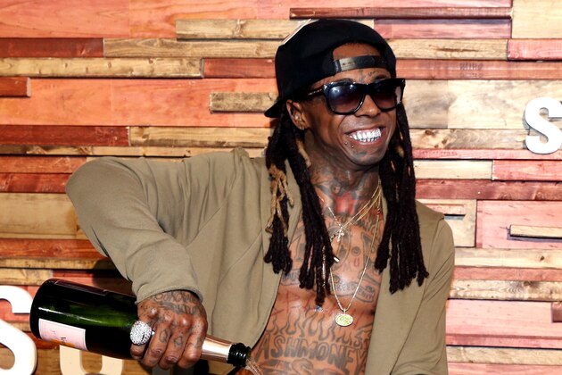 AUSTIN, TX - MARCH 12:  AUSTIN, TX - MARCH: Rapper Lil Wayne pours champagne over his Samsung Galaxy S7 at Samsung Galaxy Life Fest at SXSW 2016 on March 12, 2016 in Austin, Texas.  (Photo by Jonathan Leibson/Getty Images for Samsung)