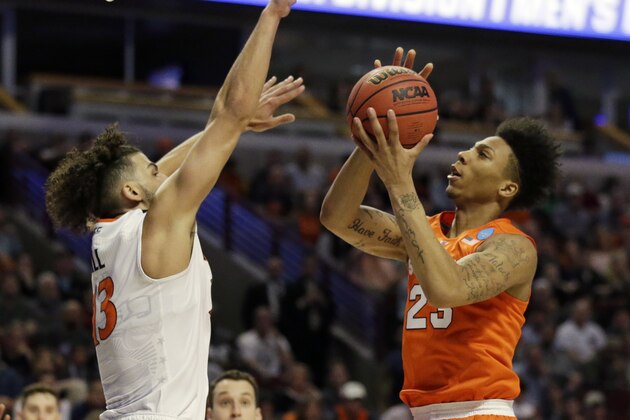Syracuse's Malachi Richardson (23) goes up for a shot against Virginia's Anthony Gill (13) during the first half of a college basketball game in the regional finals of the NCAA Tournament, Sunday, March 27, 2016, in Chicago. (AP Photo/Nam Y. Huh)