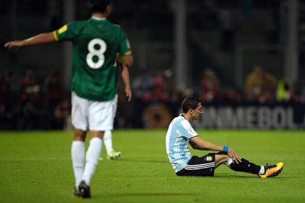 Argentina's Angel Di Maria (R) remains sitting on the field next to Bolivia's Diego Bejarano during their Russia 2018 FIFA World Cup South American Qualifiers' football match in Cordoba, Argentina, on March 29, 2016.  AFP PHOTO / JUAN MABROMATA / AFP / EITAN ABRAMOVICH        (Photo credit should read EITAN ABRAMOVICH/AFP/Getty Images)