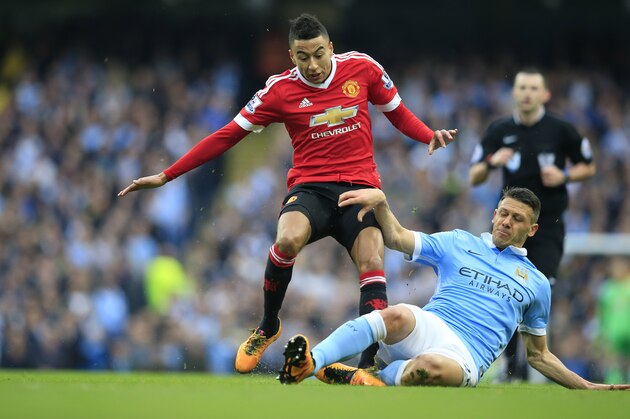 United’s Jesse Lingard, left, and Manchester City's Martin Demichelis challenge for the ball during the English Premier League soccer match between Manchester City and Manchester United at the Etihad stadium in Manchester, Sunday, March 20, 2016.(AP Photo/Jon Super)
