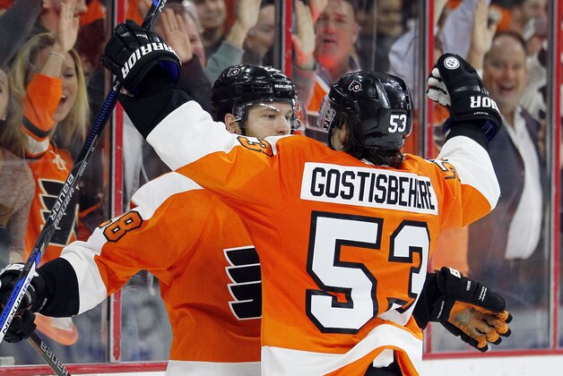 Philadelphia Flyers Shayne Gotisbehere, right, joins Claude Giroux, to celebrate after Giroux  scored the game winning goal  during the overtime period of an NHL hockey game against the  Winnipeg Jets' Monday, March 28, 2016 in Philadelphia. The Flyers won 3-2.  (AP Photo/Tom Mihalek)