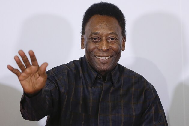 Brazilian soccer great Pele waves to fans at his book signing and autograph session as he presents a book about his life, titled in Portuguese