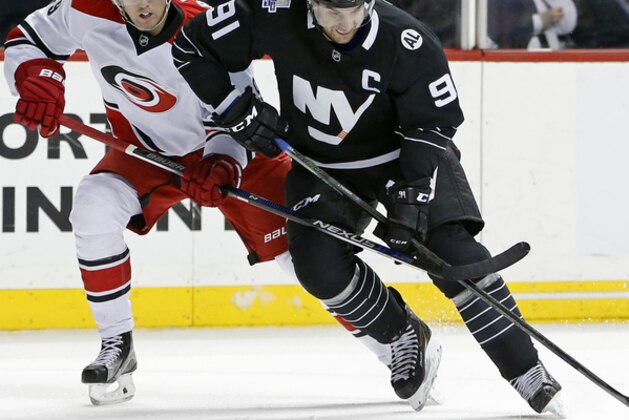 Carolina Hurricanes center Brody Sutter (48) defends New York Islanders center John Tavares (91) in the second period of an NHL hockey game in New York, Tuesday, March 29, 2016. (AP Photo/Kathy Willens)