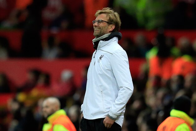 Liverpool manager Juergen Klopp reacts after Liverpool scored their first goal during the Europa League round of 16, second leg, soccer match between  Manchester United and Liverpool at Old Trafford Stadium in Manchester, England, Thursday March 17, 2016. (AP Photo/Jon Super)
