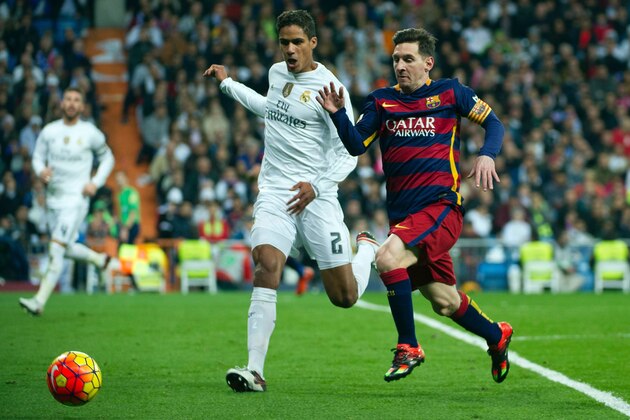 Barcelona's Argentinian forward Lionel Messi  (R) vies with Real Madrid's French defender Raphael Varane during the Spanish league 'Clasico' football match Real Madrid CF vs FC Barcelona at the Santiago Bernabeu stadium in Madrid on November 21, 2015.    AFP PHOTO / CURTO DE LA TORRE / AFP / CURTO DE LA TORRE        (Photo credit should read CURTO DE LA TORRE/AFP/Getty Images)