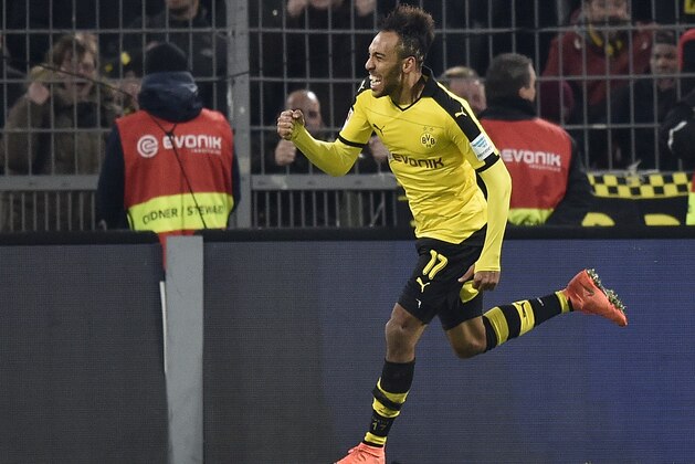Dortmund's Pierre-Emerick Aubameyang  celebrates his final goal during the German Bundesliga soccer match between Borussia Dortmund and TSG 1899 Hoffenheim in Dortmund, Germany, Sunday, Feb. 28, 2016. Dortmund defeated Hoffenheim with 3-1. (AP Photo/Martin Meissner)