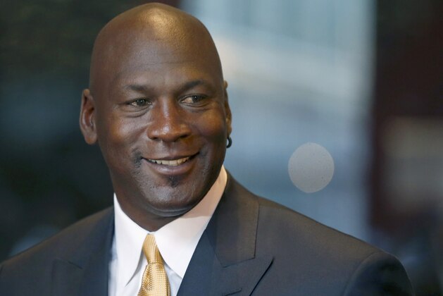 FILE - In this Aug. 21, 2015, file photo, former NBA star Michael Jordan smiles at reporters in Chicago. Nike is opening a Michael Jordan-only store in Chicago's Loop on Saturday, Oct. 24, 2015. The new Jordan Brand store will sell merchandise with the trademarked Michael Jordan